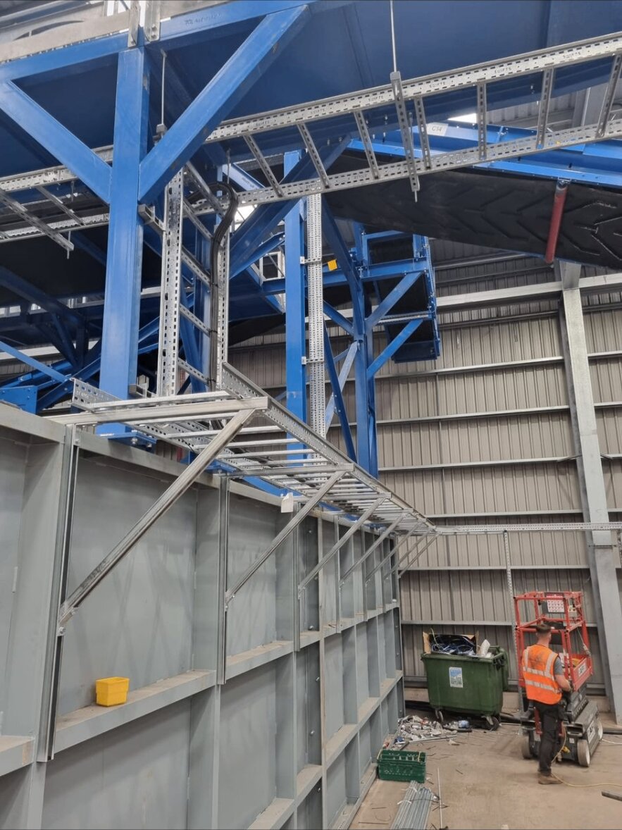 Heavy structural steelwork with galvanised cable tray and ladder rack threaded through it at a Nottinghamshire industrial fit-out